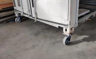 Casters installed on a shipping container