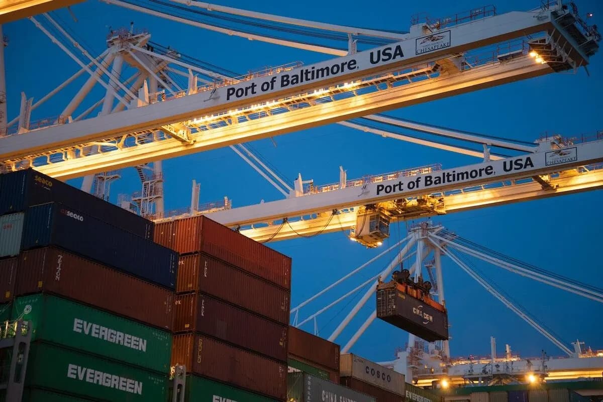 Heavy equipment moving a shipping container