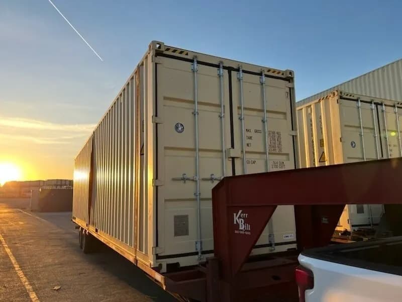 A shipping container being delivered to a residential property.