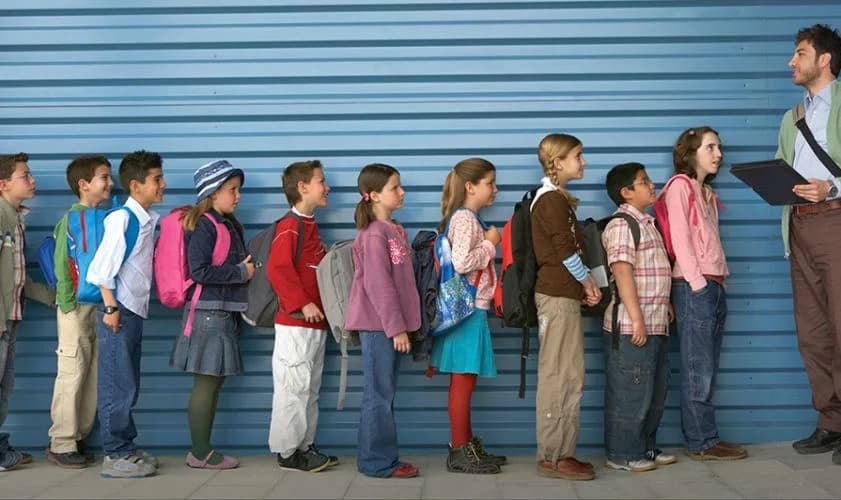 Children lined up outside a shipping container school