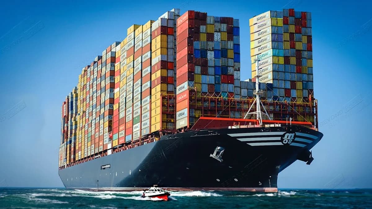 Massive container ship at sea, fully loaded with stacked shipping containers