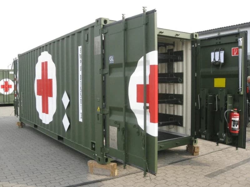 Olive shipping container fitted as a mobile field-medical station with red cross markings