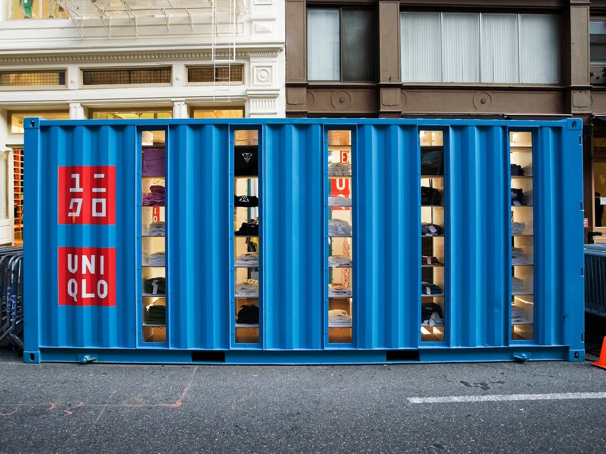 Blue UNIQLO shipping container pop-up storefront on a city street