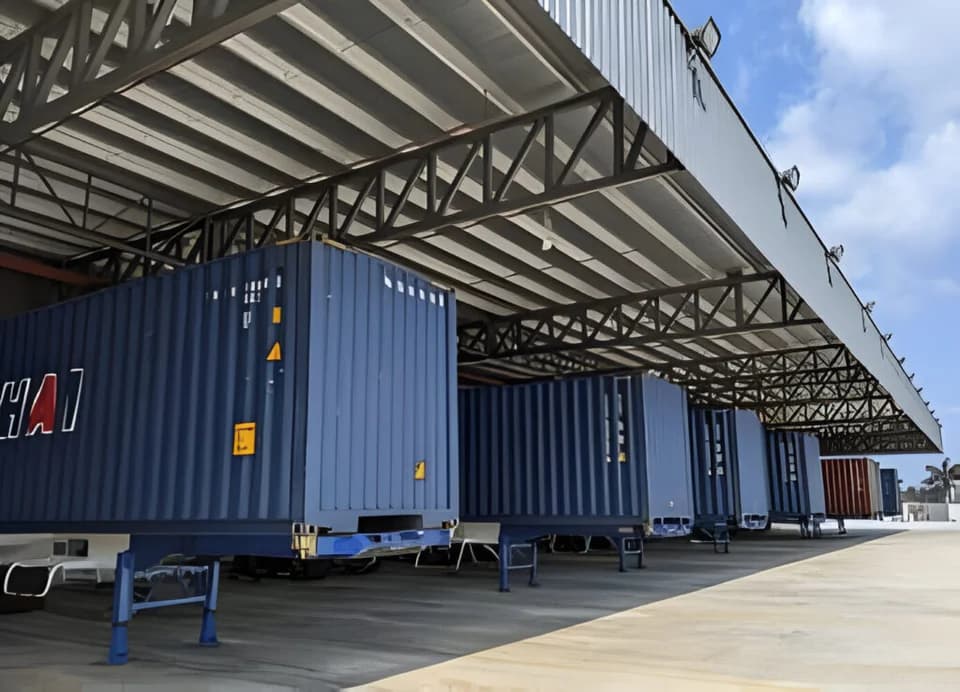 Blue shipping container storage facility with truck loading bay