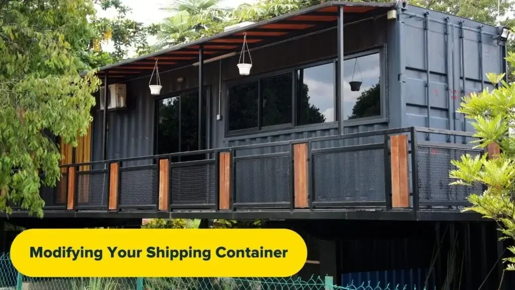 An elevated shipping container home. Graphic reads: "Modifying Your Shipping Container".