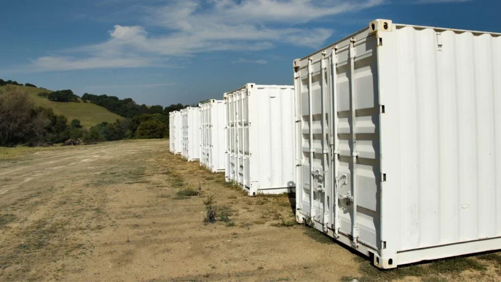 shipping containers in field